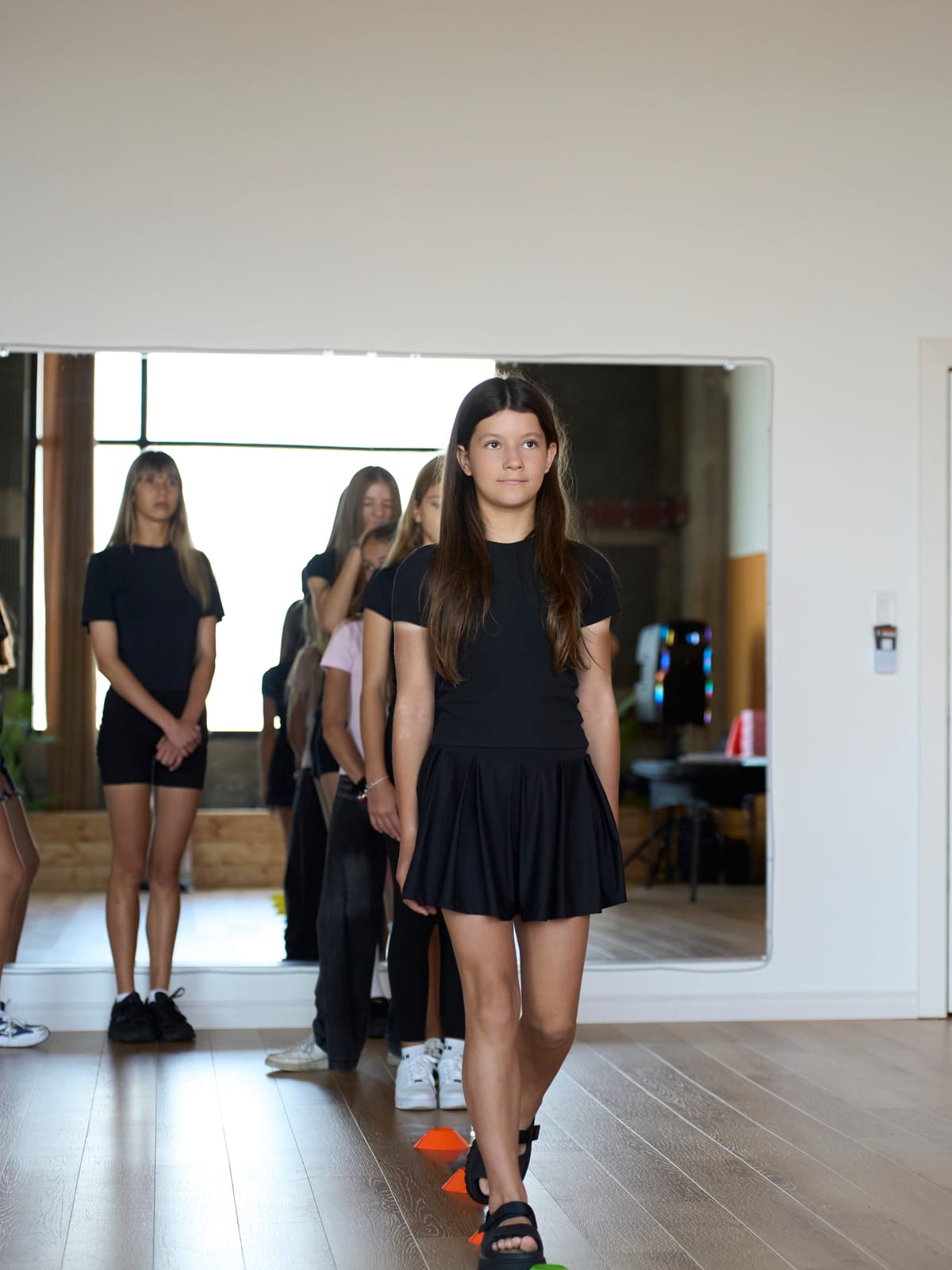 Students practising the runway walk in the studio