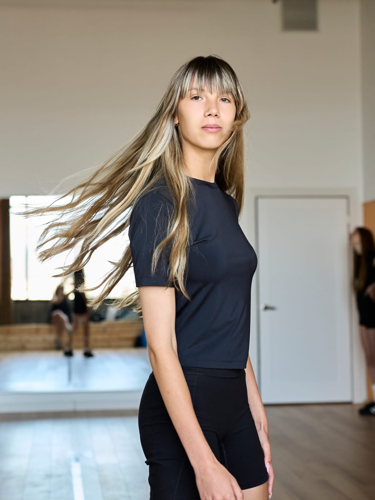 Young model mid-turn with her hair in motion