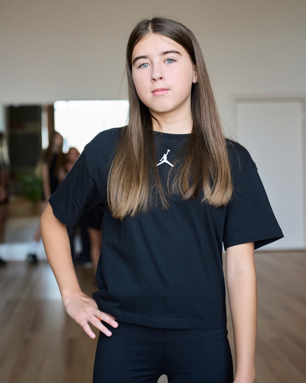 Young model standing with confidence in the D&L studio